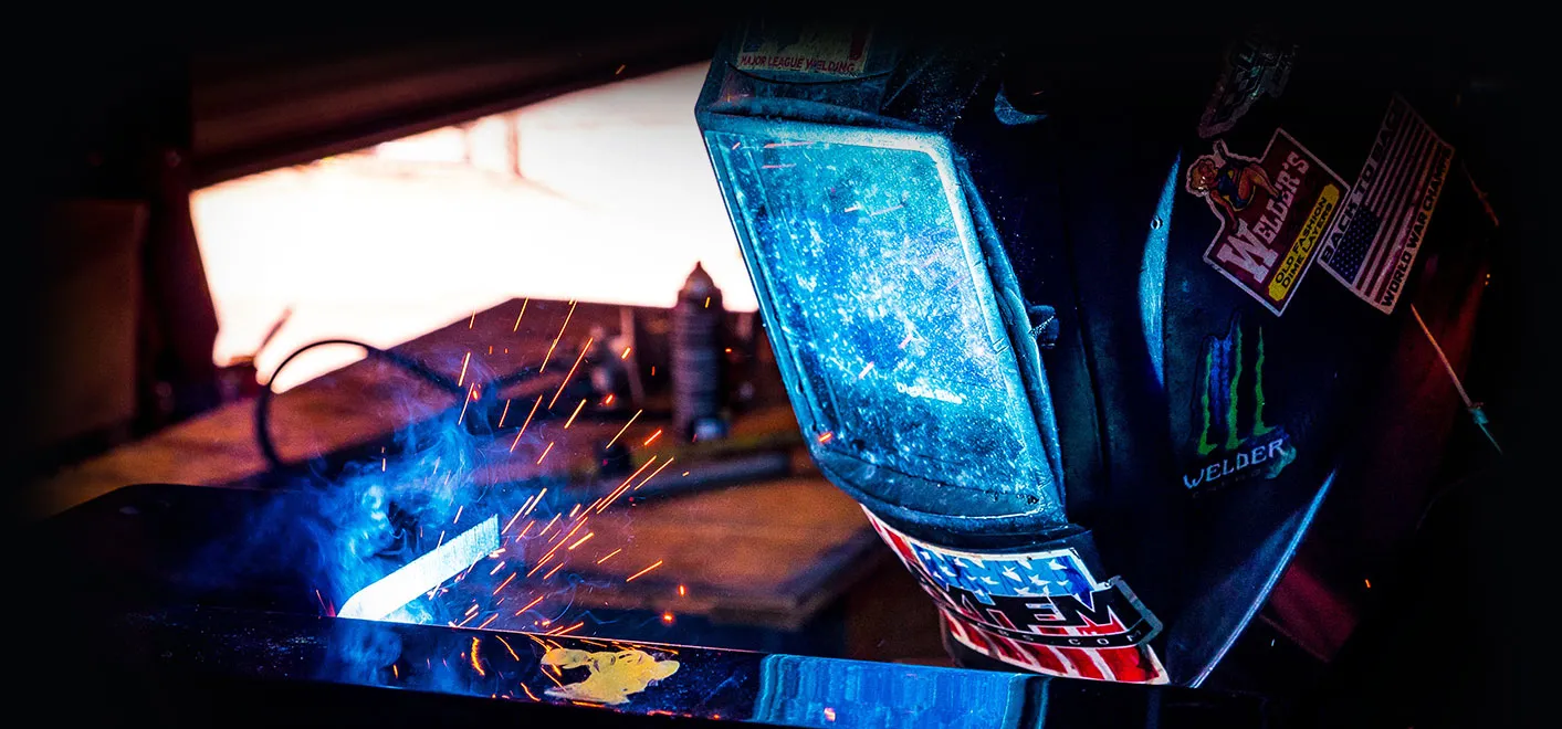 a person welding a bar of steel